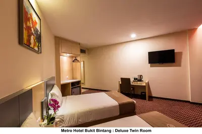 a hotel room with a bed and a desk at Metro Hotel Bukit Bintang in Kuala Lumpur