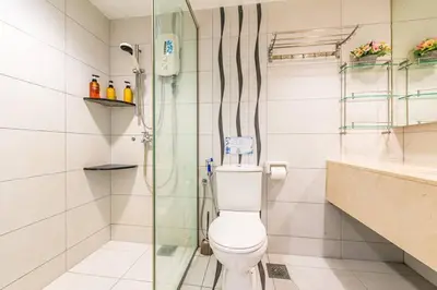 a bathroom with a toilet and a glass shower at Fahrenheit88 - China Theme Kuala Lumpur Bukit Bintang in Kuala Lumpur