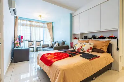 a bedroom with a large bed and a living room at Fahrenheit88 - China Theme Kuala Lumpur Bukit Bintang in Kuala Lumpur