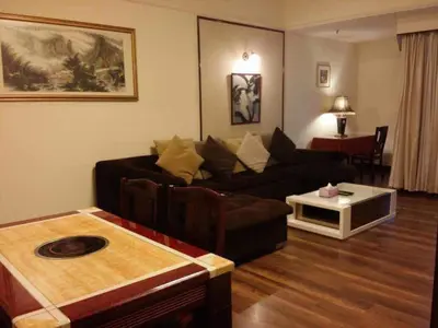 a living room with a couch and a table at Fantazya Suites Times Square in Kuala Lumpur