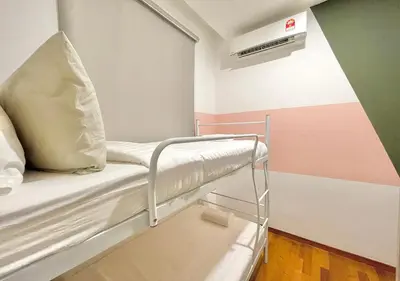 a hospital bed with a pillow on it in a room at KL Gateway Premium Residences by Moka in Kuala Lumpur