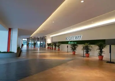 a lobby of a building with potted plants in it at KL Gateway Premium Residences by Moka in Kuala Lumpur