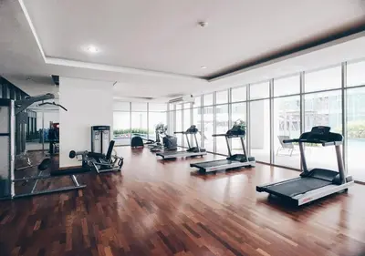 a gym with treadmills and ellipticals in a room at KL Gateway Premium Residences by Moka in Kuala Lumpur