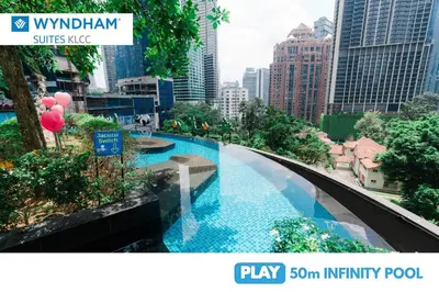 a view of a swimming pool in a city at Wyndham Suites KLCC in Kuala Lumpur