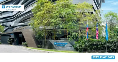a building with two flags in front of it at Wyndham Suites KLCC in Kuala Lumpur