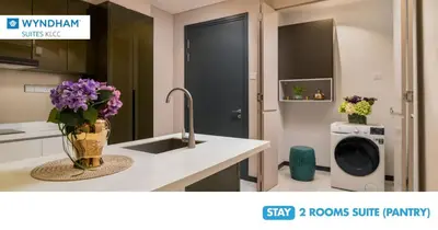 a kitchen with a sink and a washing machine at Wyndham Suites KLCC in Kuala Lumpur