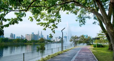 a park with a lake and a city in the background at Titiwangsa Cabin Retreats by Vale Pine in Kuala Lumpur