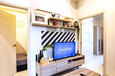 a living room with a flat screen tv on a wall at Arte Mont Kiara by Airhost in Kuala Lumpur