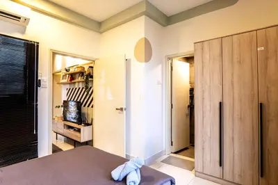 a room with a bed and a sliding door at Arte Mont Kiara by Airhost in Kuala Lumpur
