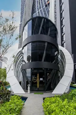 a building with a revolving door in a city at Arte Mont Kiara by Airhost in Kuala Lumpur