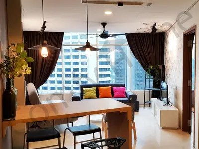 a living room with a table and a couch at KLCC Service suites by Home Sweet Home in Kuala Lumpur