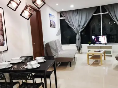 a living room with a table and chairs and a couch at KLCC Service suites by Home Sweet Home in Kuala Lumpur