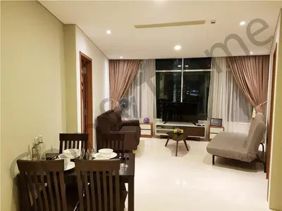 a living room with a table and chairs and a couch at KLCC Service suites by Home Sweet Home in Kuala Lumpur
