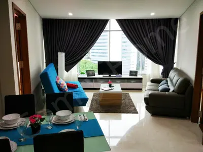 a living room with a couch and a tv at KLCC Service suites by Home Sweet Home in Kuala Lumpur