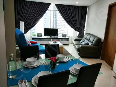 a living room with a dining table and a couch at KLCC Service suites by Home Sweet Home in Kuala Lumpur