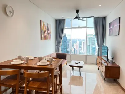 a living room with a table and a couch at Sky Suites KLCC by GENESIS in Kuala Lumpur