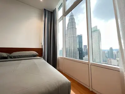 a bedroom with a bed and a large window at Sky Suites KLCC by GENESIS in Kuala Lumpur