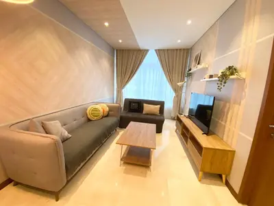 a living room with a couch and a television at Sky Suites KLCC by GENESIS in Kuala Lumpur
