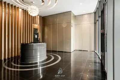a lobby with a black floor and a chandelier at KLCC Homestay Vacation Sky Suites KLCC Birdy Stay in Kuala Lumpur
