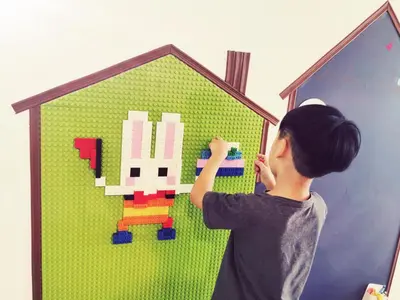 a boy playing with a lego figure in a house at Aishiteru Homestay in Kuala Lumpur