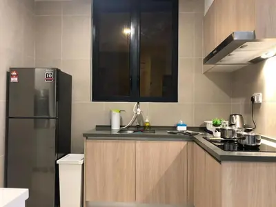 a kitchen with a refrigerator and a sink at KL Gateway Premium Residence I HomeBrickz in Kuala Lumpur