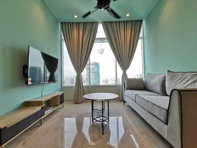 a living room with a couch and a table at Sky Suites KLCC by Autumn Suites Premium Stay in Kuala Lumpur