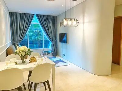 a dining room with a table and chairs and a window at Sky Suites KLCC by Autumn Suites Premium Stay in Kuala Lumpur