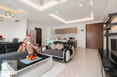 a living room with a teddy bear sitting on a couch at Regalia Residence @ KLCC View Sky Pool by KC in Kuala Lumpur