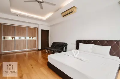 a bedroom with a bed and a chair at Regalia Residence @ KLCC View Sky Pool by KC in Kuala Lumpur