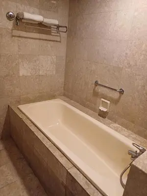 a white bath tub in a bathroom at Times Square Grand Service Suite in Kuala Lumpur