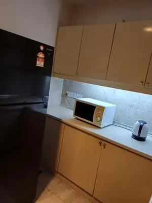 a microwave sitting on top of a kitchen counter at Times Square Grand Service Suite in Kuala Lumpur