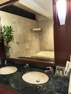 a bathroom with two sinks and a large mirror at Times Square Grand Service Suite in Kuala Lumpur
