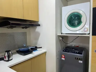 a kitchen with a washing machine and a microwave at Stylish Romantic Couples Getaway at KL City 1419 in Kuala Lumpur