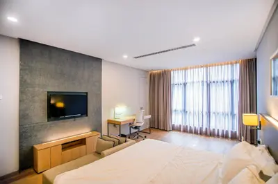 a bedroom with a bed and a flat screen tv at 188 Suites KLCC by CoBNB in Kuala Lumpur