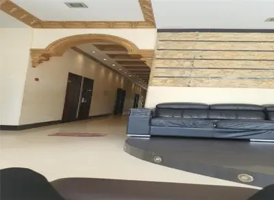 a black leather couch sitting in a hallway at GOLDEN PALACE in Kuala Lumpur