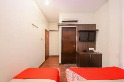 a small room with two beds and a television at GOLDEN PALACE in Kuala Lumpur