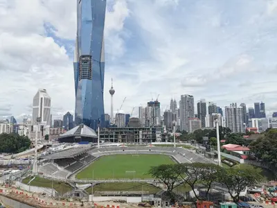 a stadium in a city with a soccer field at OPUS RESIDENCE KL I HomeBrickz in Kuala Lumpur