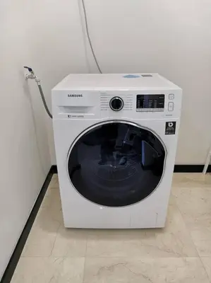 a white washing machine sitting in a room at OPUS RESIDENCE KL I HomeBrickz in Kuala Lumpur