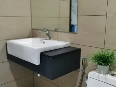 a bathroom with a white sink and a mirror at OPUS RESIDENCE KL I HomeBrickz in Kuala Lumpur