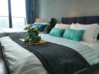 a large bed with a tray with a plant on it at OPUS RESIDENCE KL I HomeBrickz in Kuala Lumpur