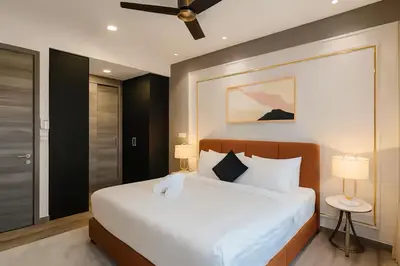 a bedroom with a large white bed with two lamps at Agile Delima Residence Bukit Bintang in Kuala Lumpur