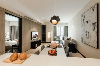 a living room with a couch and a table at Ascott Star KLCC Kuala Lumpur in Kuala Lumpur