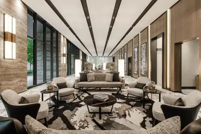 a lobby with a couch and chairs and tables at Ascott Star KLCC Kuala Lumpur in Kuala Lumpur