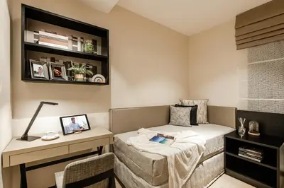 a small bedroom with a bed and a desk at Ascott Star KLCC Kuala Lumpur in Kuala Lumpur