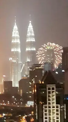 a view of a city with fireworks in the sky at Cozy Regalia KL 吉隆玻 LRT & KTM @1 Parking & WIFI in Kuala Lumpur