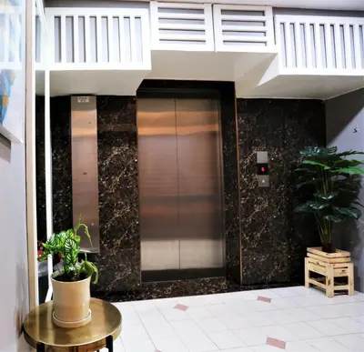 a elevator in a building with two potted plants at Orkid Hills Hotel at Bukit Bintang in Kuala Lumpur