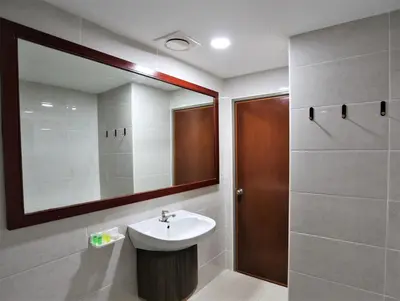 a bathroom with a sink and a mirror at Orkid Hills Hotel at Bukit Bintang in Kuala Lumpur