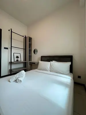 a bedroom with a large white bed with white pillows at Opus Residence KL by EUcation Home in Kuala Lumpur
