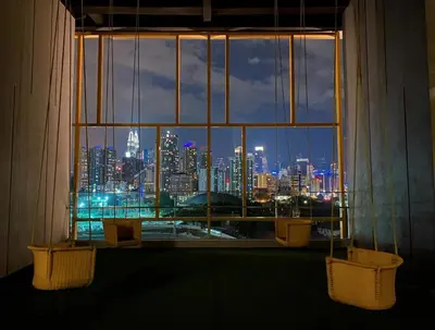 a view of a city skyline from a window at Opus Residence KL by EUcation Home in Kuala Lumpur