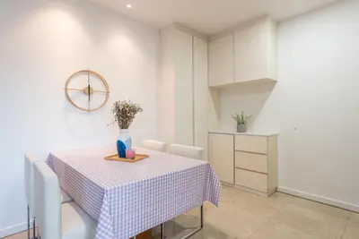 a dining room with a table with a vase on it at FAIRLANE 2mins walk to Bukit Bintang BEST SUNSET view 2BR 8-1 WIFI 100mbps in Kuala Lumpur